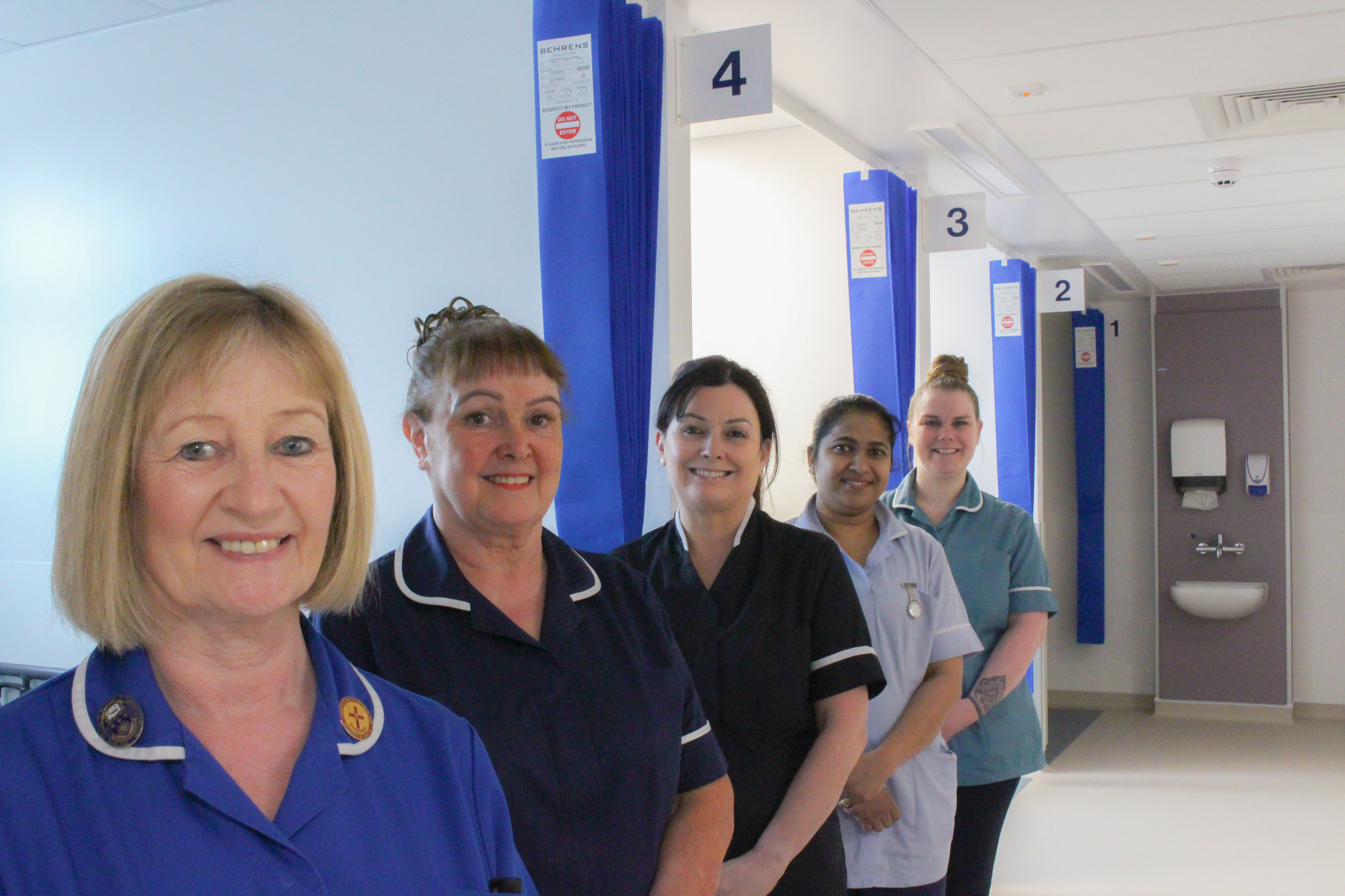 Staff smiling while standing in the new Day Case Unit.